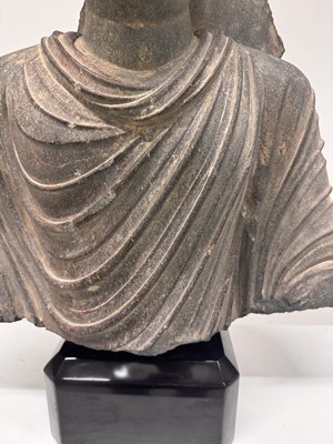 Lot 196 - A LARGE CARVED GANDHARA GREY SCHIST BUST OF THE HISTORICAL BUDDHA, SIDDHARTHA GAUTAMA SHAKYAMUNI