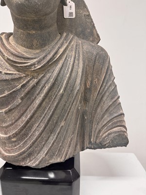 Lot 196 - A LARGE CARVED GANDHARA GREY SCHIST BUST OF THE HISTORICAL BUDDHA, SIDDHARTHA GAUTAMA SHAKYAMUNI