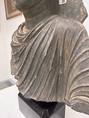 Lot 196 - A LARGE CARVED GANDHARA GREY SCHIST BUST OF THE HISTORICAL BUDDHA, SIDDHARTHA GAUTAMA SHAKYAMUNI