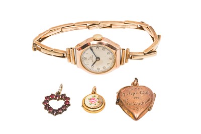 Lot 75 - A WATCH AND THREE CHARMS