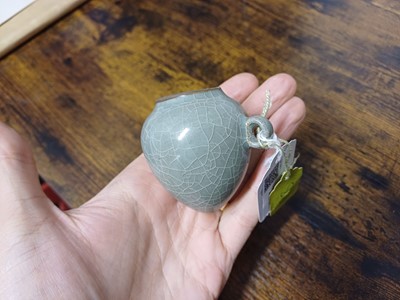 Lot 291 - A CHINESE LONGQUAN CELADON-GLAZED BIRD FEEDER