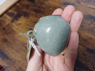 Lot 291 - A CHINESE LONGQUAN CELADON-GLAZED BIRD FEEDER