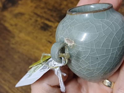 Lot 291 - A CHINESE LONGQUAN CELADON-GLAZED BIRD FEEDER