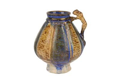 Lot 41 - A KASHAN POTTERY JUG WITH LION HANDLE