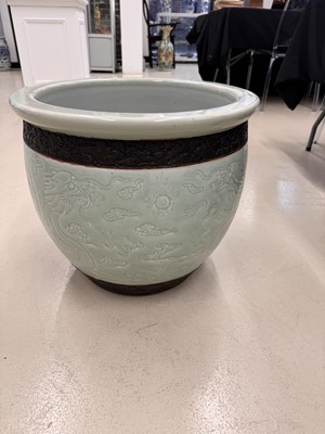 Lot 298 - A VERY LARGE CHINESE CELADON-GLAZED 'DRAGON' FISH BOWL