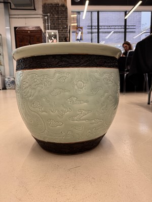 Lot 298 - A VERY LARGE CHINESE CELADON-GLAZED 'DRAGON' FISH BOWL