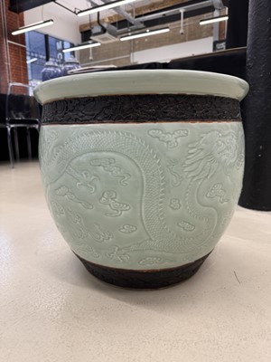 Lot 298 - A VERY LARGE CHINESE CELADON-GLAZED 'DRAGON' FISH BOWL