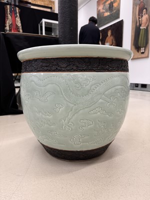 Lot 298 - A VERY LARGE CHINESE CELADON-GLAZED 'DRAGON' FISH BOWL