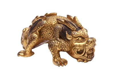 Lot 575 - A CHINESE GILT-BRONZE 'MYTHICAL BEAST' BRONZE WEIGHT