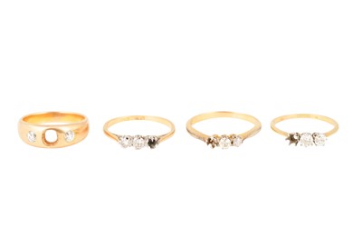 Lot 11 - FOUR THREE-STONE DIAMOND RINGS