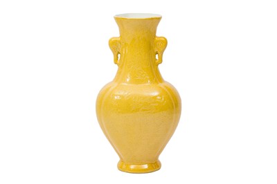 Lot 477 - A CHINESE YELLOW-GLAZED TWIN-HANDLED VASE