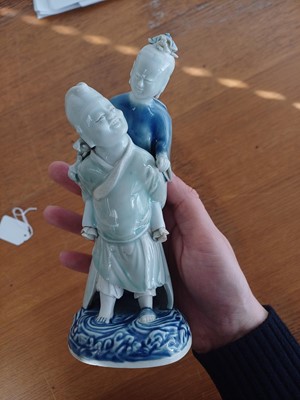 Lot 473 - A Chinese glazed biscuit figure group, Qing dynasty, Qianlong period