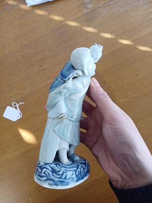 Lot 473 - A Chinese glazed biscuit figure group, Qing dynasty, Qianlong period