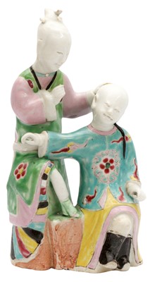 Lot 83 - A CHINESE FAMILLE-ROSE 'EAR CLEANING' FIGURE GROUP