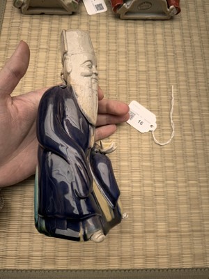 Lot 429 - A Chinese biscuit figure of an official, Qing dynasty, Kangxi period