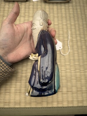 Lot 429 - A Chinese biscuit figure of an official, Qing dynasty, Kangxi period