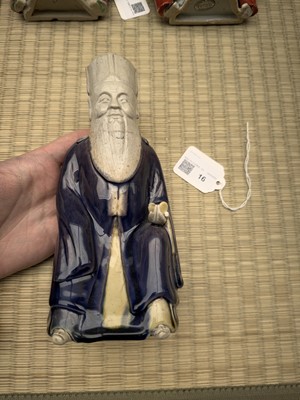 Lot 429 - A Chinese biscuit figure of an official, Qing dynasty, Kangxi period