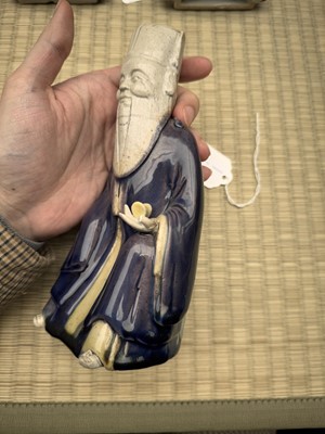 Lot 429 - A Chinese biscuit figure of an official, Qing dynasty, Kangxi period