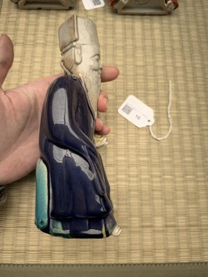 Lot 429 - A Chinese biscuit figure of an official, Qing dynasty, Kangxi period