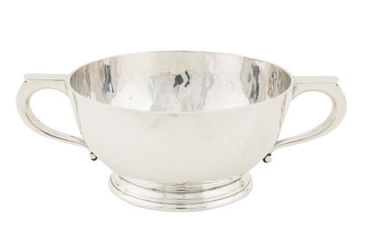 Lot 260 - A heavy George V arts and crafts sterling silver twin handled porringer bowl, Birmingham 1926 by Mappin and Webb