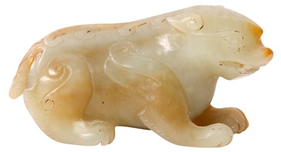 Lot 185 - A CHINESE CELADON AND RUSSET JADE 'BIXIE' CARVING