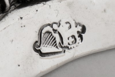 Lot 470 - A pair of George III Irish sterling silver candlesticks, Dublin 1776 by William Hughes (active 1767-84)