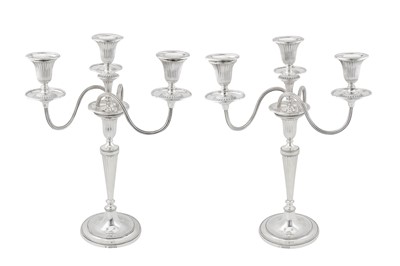 Lot 411 - A pair of Victorian sterling silver candelabra, the candlesticks London 1880 by Martin Hall and Co