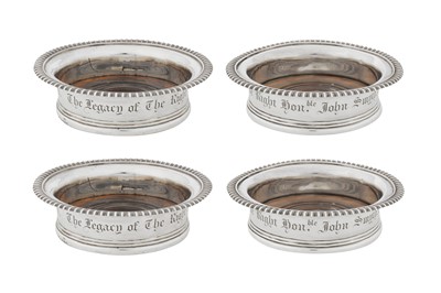 Lot 443 - A set of four George III sterling silver wine coasters, London 1812 by John William Storey and William Elliott