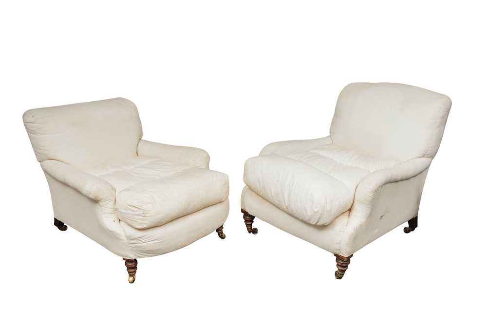Lot 69 - A near pair of deep seated upholstered Howard & Sons armchairs, early 20th Century