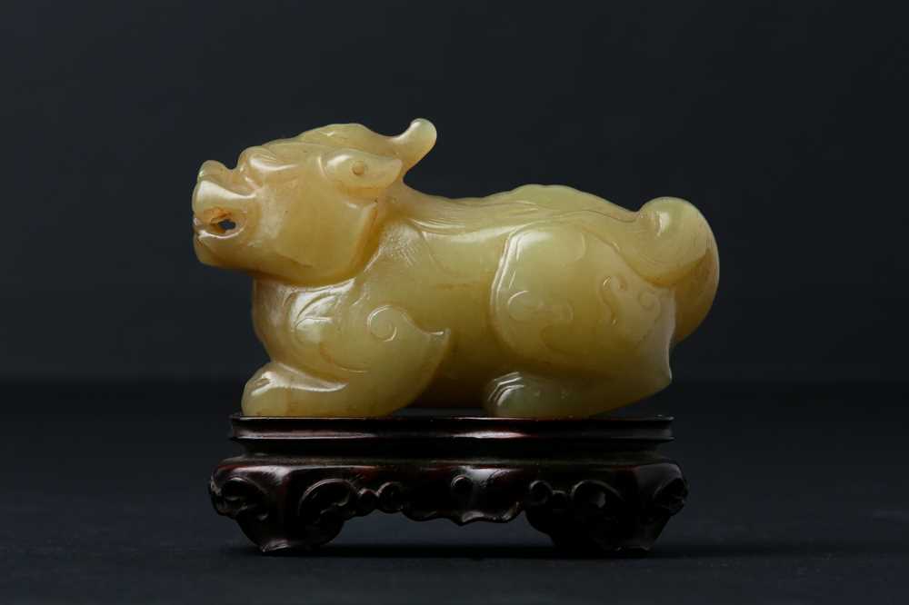 Lot 62 - A CHINESE YELLOW JADE CARVING OF A MYTHICAL BEAST