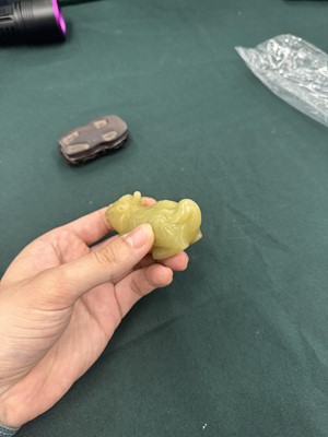 Lot 62 - A CHINESE YELLOW JADE CARVING OF A MYTHICAL BEAST