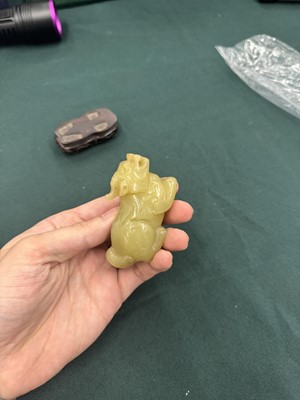 Lot 62 - A CHINESE YELLOW JADE CARVING OF A MYTHICAL BEAST