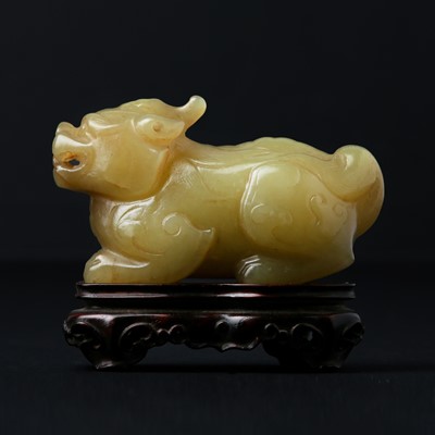 Lot 578 - A Chinese yellow jade carving of a mythical beast, 20th century