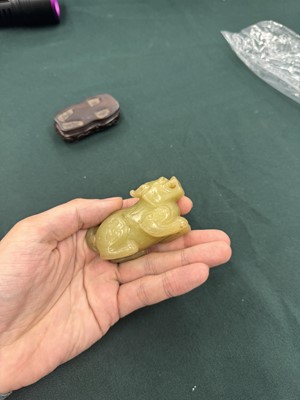 Lot 62 - A CHINESE YELLOW JADE CARVING OF A MYTHICAL BEAST