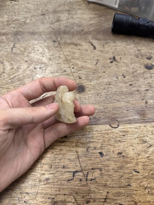 Lot 96 - A CHINESE CELADON JADE 'LION DOG' GROUP