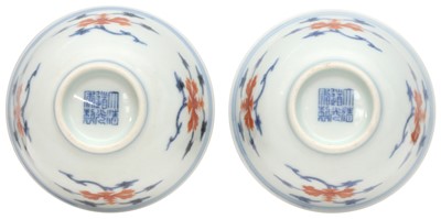 Lot 516 - A pair of Chinese iron-red and underglaze blue 'lotus' bowls, 20th Century