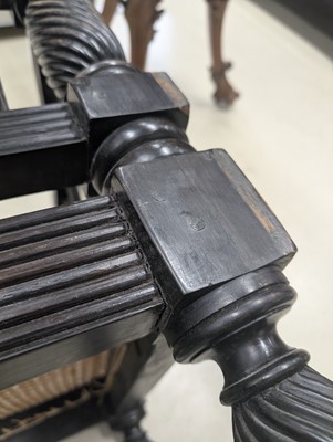 Lot 39 - An early 19th century Ceylon (Sri Lanka) carved and caned ebony sofa