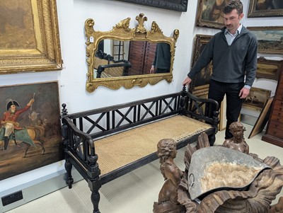 Lot 39 - An early 19th century Ceylon (Sri Lanka) carved and caned ebony sofa