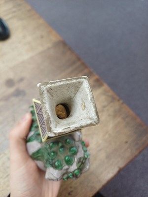 Lot 13 - A CHINESE BISCUIT FAMILLE-VERTE 'LION DOG' CANDLE HOLDER