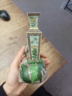 Lot 13 - A CHINESE BISCUIT FAMILLE-VERTE 'LION DOG' CANDLE HOLDER