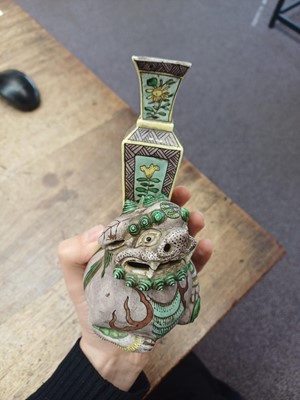 Lot 13 - A CHINESE BISCUIT FAMILLE-VERTE 'LION DOG' CANDLE HOLDER