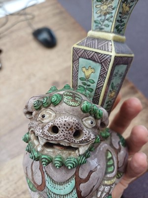 Lot 13 - A CHINESE BISCUIT FAMILLE-VERTE 'LION DOG' CANDLE HOLDER