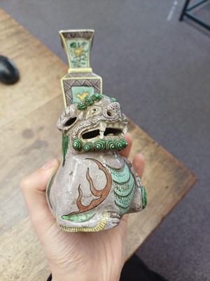 Lot 13 - A CHINESE BISCUIT FAMILLE-VERTE 'LION DOG' CANDLE HOLDER