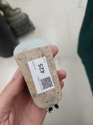 Lot 425 - Three Chinese biscuit famille-verte models of shoes, Qing dynasty, Kangxi period