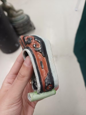 Lot 425 - Three Chinese biscuit famille-verte models of shoes, Qing dynasty, Kangxi period