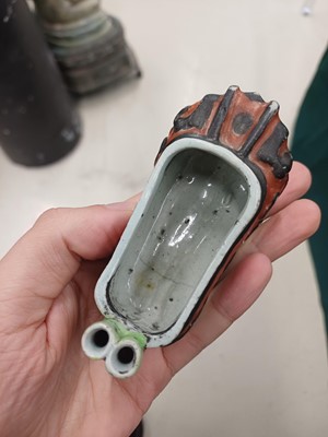 Lot 425 - Three Chinese biscuit famille-verte models of shoes, Qing dynasty, Kangxi period