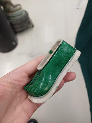 Lot 425 - Three Chinese biscuit famille-verte models of shoes, Qing dynasty, Kangxi period