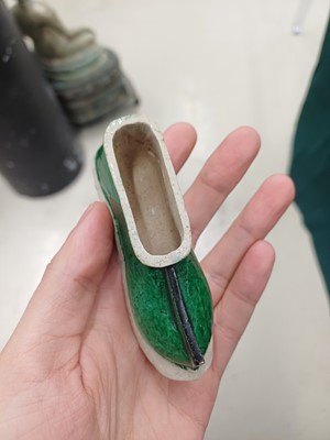 Lot 425 - Three Chinese biscuit famille-verte models of shoes, Qing dynasty, Kangxi period