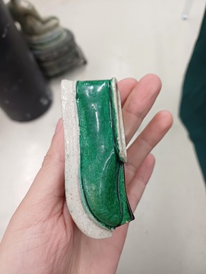 Lot 425 - Three Chinese biscuit famille-verte models of shoes, Qing dynasty, Kangxi period