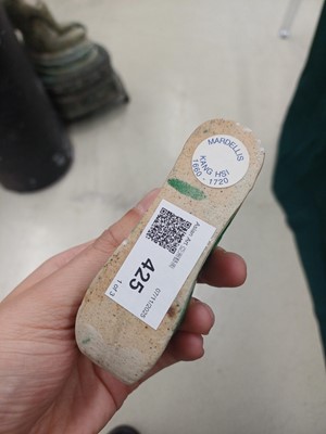 Lot 425 - Three Chinese biscuit famille-verte models of shoes, Qing dynasty, Kangxi period